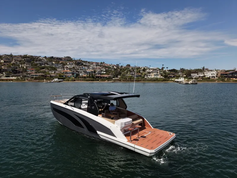 Slide: The Image of The image shows a modern motorboat on the water with a cityscape in the background. - 2