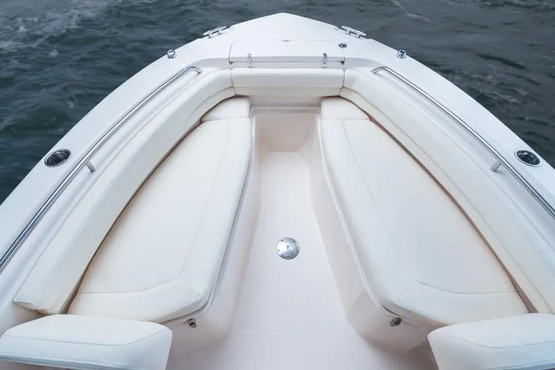 Slide: The Image of 2025 Grady-White Fisherman 257 boat interior with cushioned seating and stainless steel rails. - 7