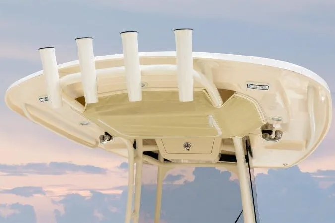 Slide: The Image of 2025 Grady-White Fisherman 257 boat top with rod holders against sunset sky. - 9