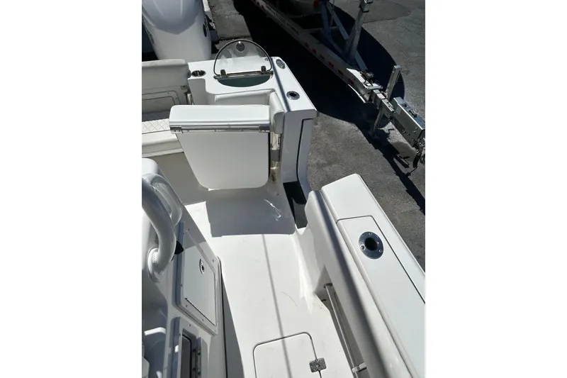 Slide: The Image of 2018 Sportsman Open 282 Center Console boat interior with seating and storage. - 11