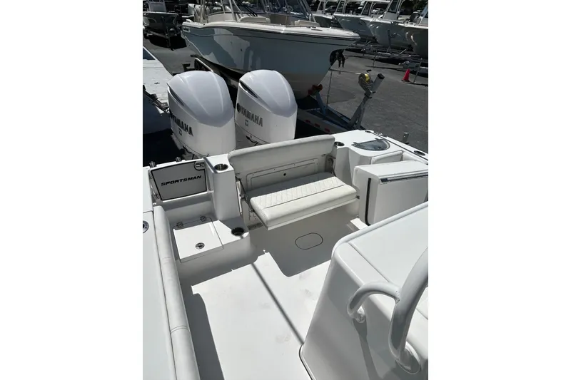Slide: The Image of 2018 Sportsman Open 282 Center Console boat with twin Yamaha engines, docked outdoors. - 4