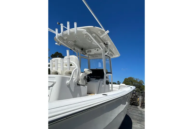 Slide: The Image of 2018 Sportsman Open 282 Center Console boat under clear blue sky. - 5