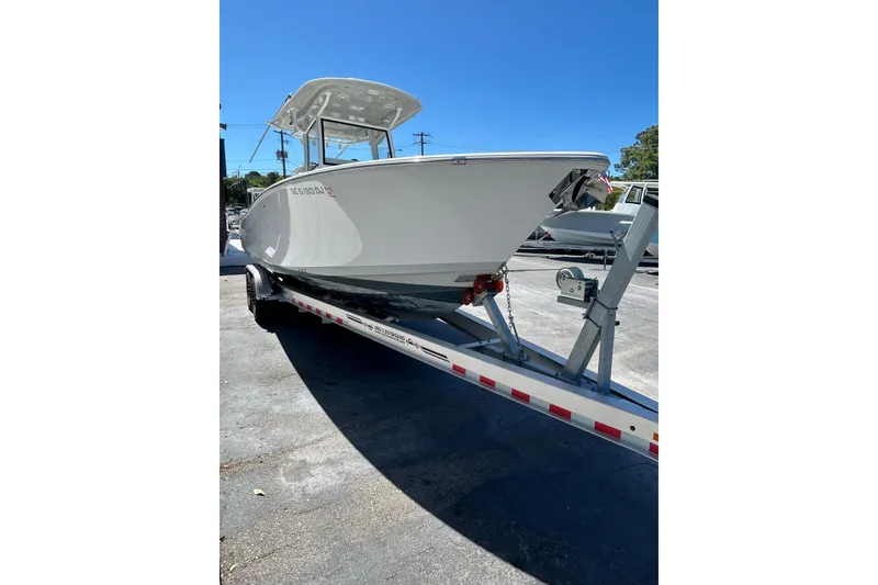 Slide: The Image of 2018 Sportsman Open 282 Center Console boat on trailer, parked outdoors. - 6