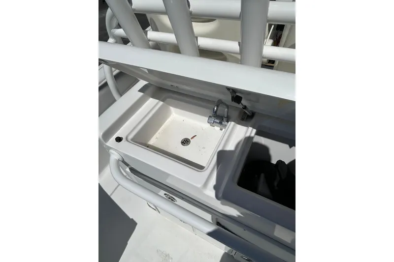 Slide: The Image of 2018 Sportsman Open 282 Center Console boat sink and storage area. - 9