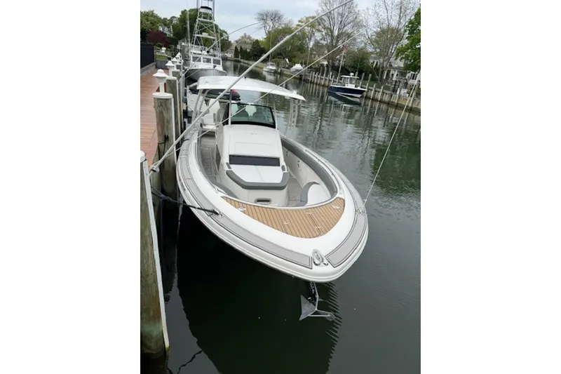 The Image of 2016 Chris-Craft Catalina 34 boat docked in a serene marina setting. - 0