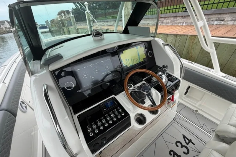 Slide: The Image of 2016 Chris-Craft Catalina 34 helm with modern navigation system and wooden steering wheel. - 4