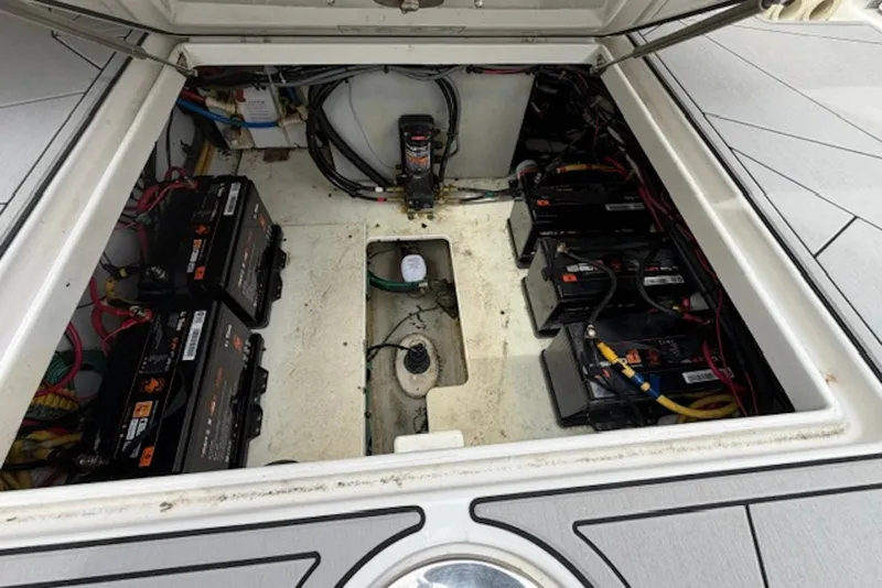 Slide: The Image of Battery compartment of a 2016 Chris-Craft Catalina 34 boat, showcasing multiple batteries and wiring. - 7