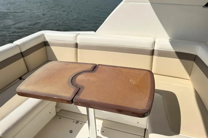 Slide: The Image of Luxurious seating area on a 2013 Sea Ray 450 Sundancer yacht with wooden table. - 16