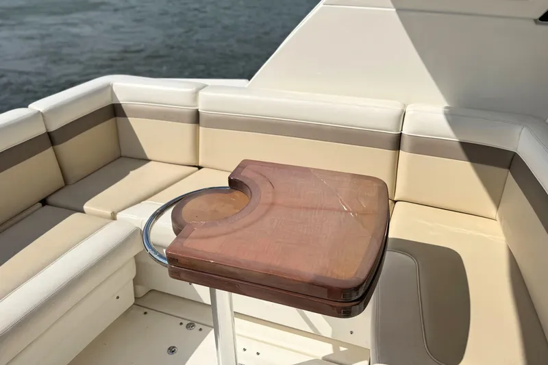 Slide: The Image of Luxurious seating area on a 2013 Sea Ray 450 Sundancer yacht with wooden table. - 17