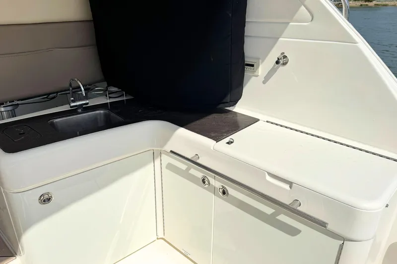Slide: The Image of Outdoor kitchenette on 2013 Sea Ray 450 Sundancer yacht with sink and storage. - 18