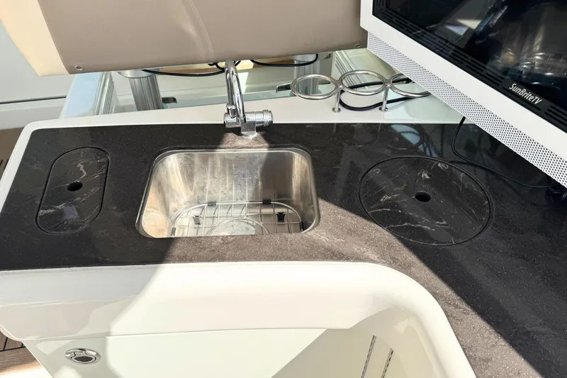 Slide: The Image of Luxury yacht kitchen sink area on 2013 Sea Ray 450 Sundancer with sleek countertop design. - 20