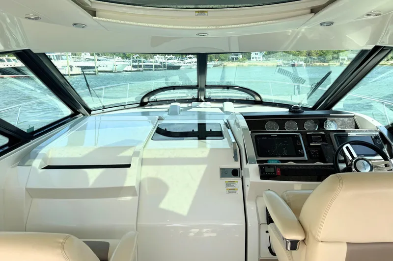 Slide: The Image of Cockpit view of 2013 Sea Ray 450 Sundancer yacht with modern navigation controls. - 21