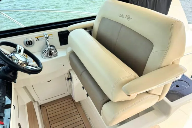 Slide: The Image of Captain's seat and helm of 2013 Sea Ray 450 Sundancer yacht, featuring luxurious design. - 25