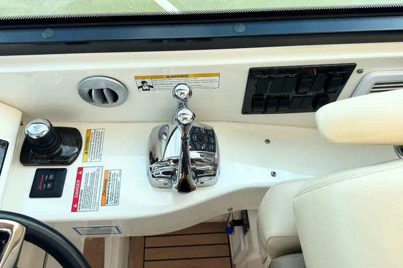 Slide: The Image of Control panel of a 2013 Sea Ray 450 Sundancer yacht, featuring throttle and switches. - 27