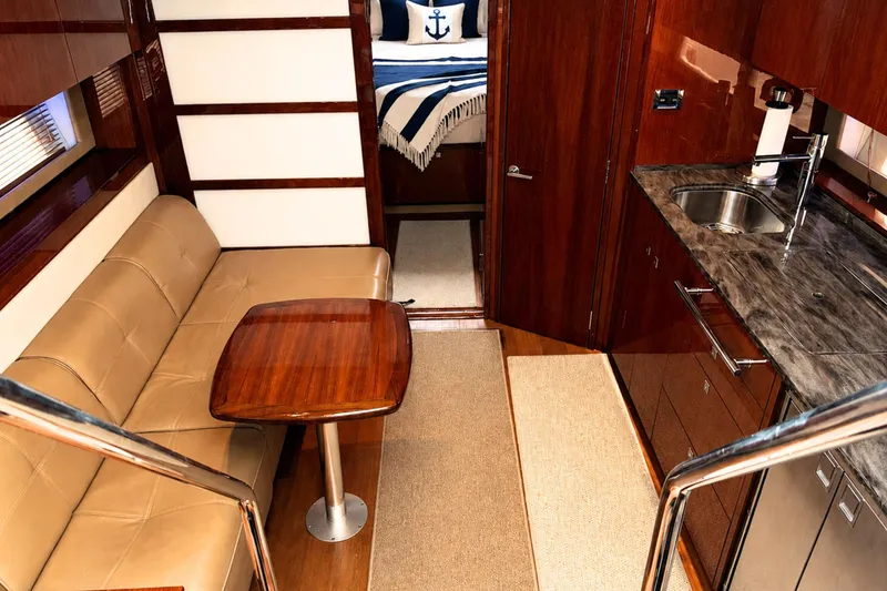 Slide: The Image of Luxurious interior of 2013 Sea Ray 450 Sundancer yacht with elegant seating and kitchenette. - 28