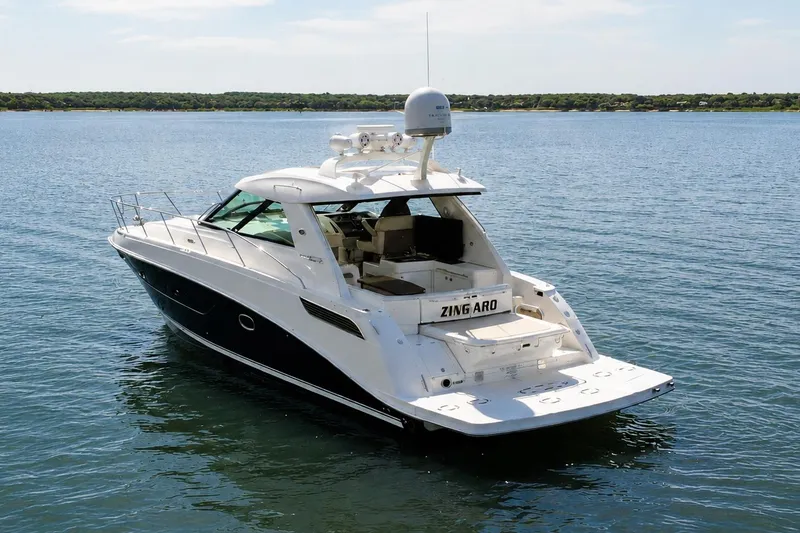 Slide: The Image of 2013 Sea Ray 450 Sundancer yacht on calm water, rear view. - 3