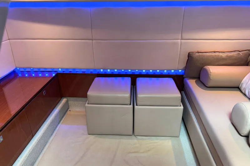 Slide: The Image of Interior of 2013 Sea Ray 450 Sundancer with modern seating and blue LED lighting. - 31