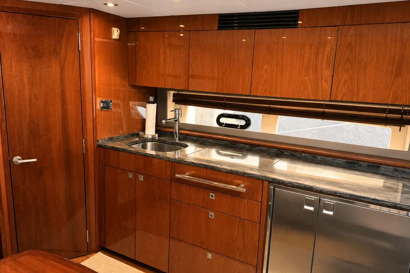 Slide: The Image of Luxurious 2013 Sea Ray 450 Sundancer yacht kitchen with wood cabinetry and modern appliances. - 35
