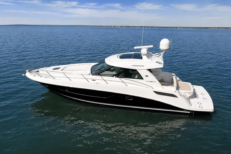 Slide: The Image of 2013 Sea Ray 450 Sundancer yacht cruising on calm blue waters. - 4