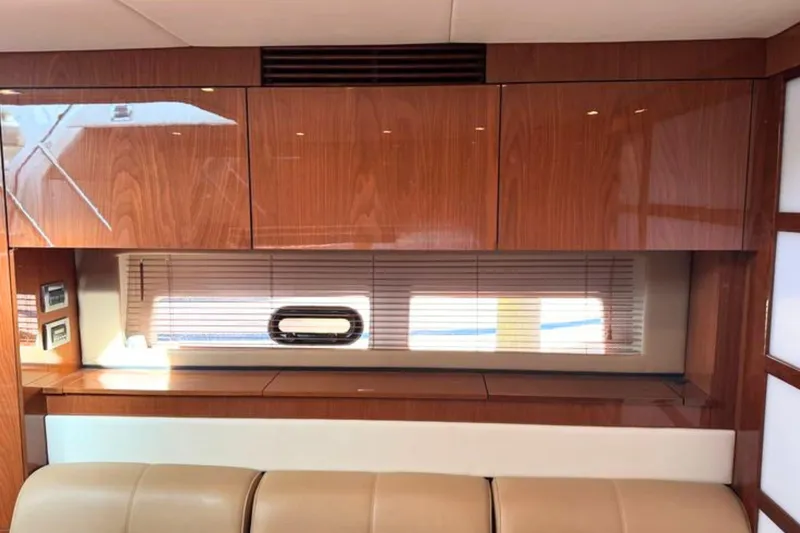 Slide: The Image of Luxurious interior of 2013 Sea Ray 450 Sundancer yacht with wood cabinetry and window blinds. - 40
