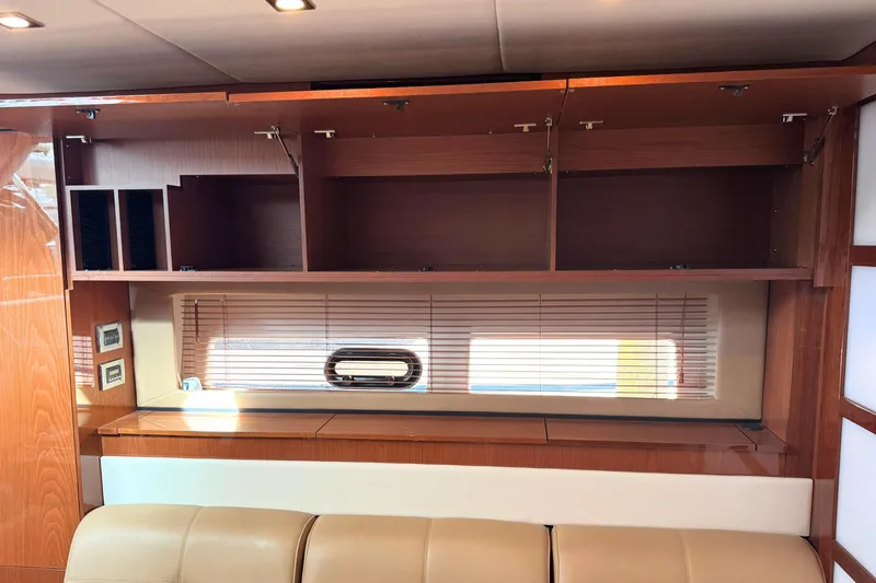 Slide: The Image of Interior of 2013 Sea Ray 450 Sundancer yacht with wooden cabinets and window blinds. - 41