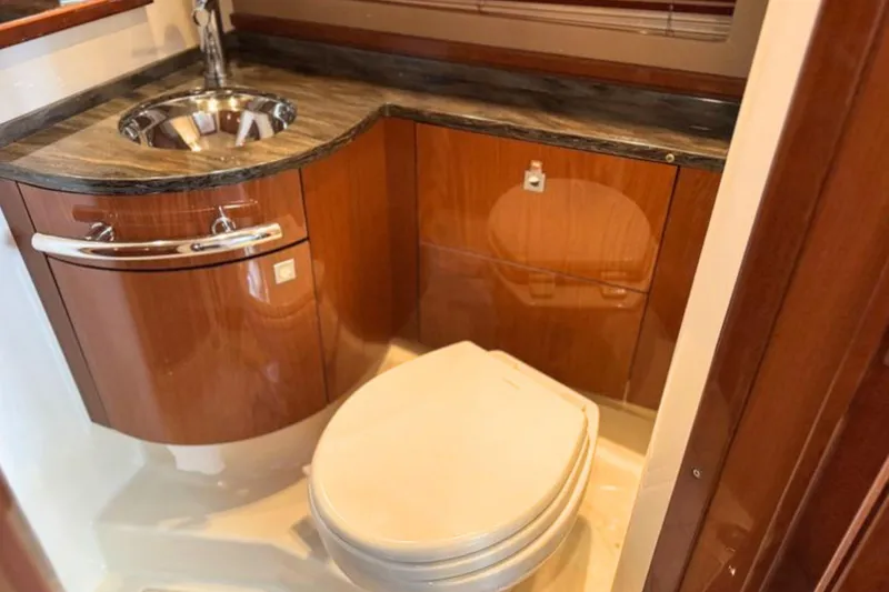 Slide: The Image of Luxurious bathroom in 2013 Sea Ray 450 Sundancer yacht with wood cabinetry and modern fixtures. - 48