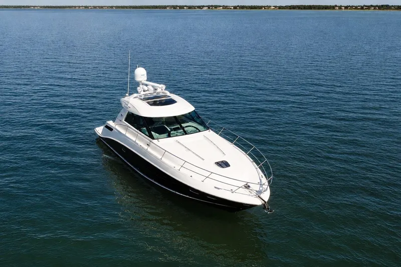 Slide: The Image of 2013 Sea Ray 450 Sundancer yacht cruising on calm blue waters. - 5