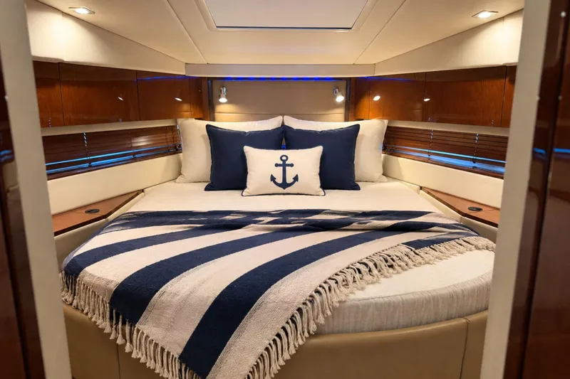Slide: The Image of Luxurious 2013 Sea Ray 450 Sundancer cabin with nautical-themed bedding and elegant wood finishes. - 50