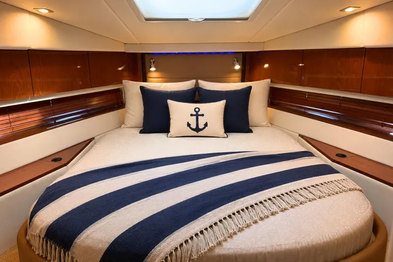 Slide: The Image of Luxurious cabin interior of 2013 Sea Ray 450 Sundancer yacht with nautical-themed bedding. - 51