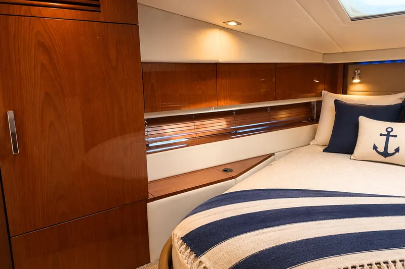 Slide: The Image of Luxurious cabin interior of 2013 Sea Ray 450 Sundancer yacht with nautical-themed decor. - 52