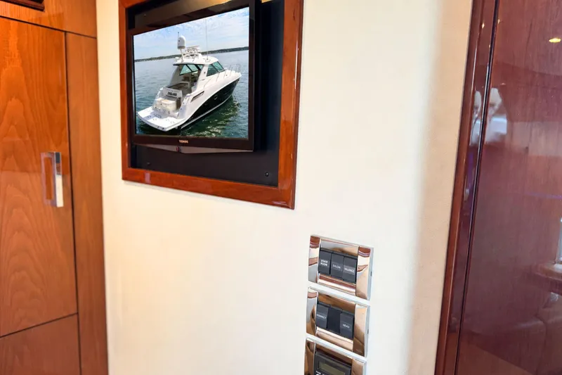 Slide: The Image of Interior view of a 2013 Sea Ray 450 Sundancer yacht with a wall-mounted TV. - 56