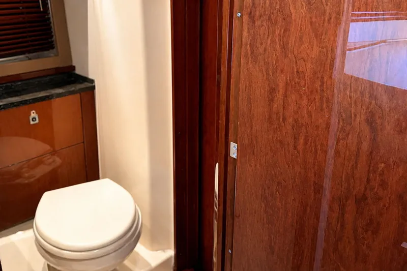 Slide: The Image of Bathroom interior of 2013 Sea Ray 450 Sundancer yacht with wooden cabinetry. - 58