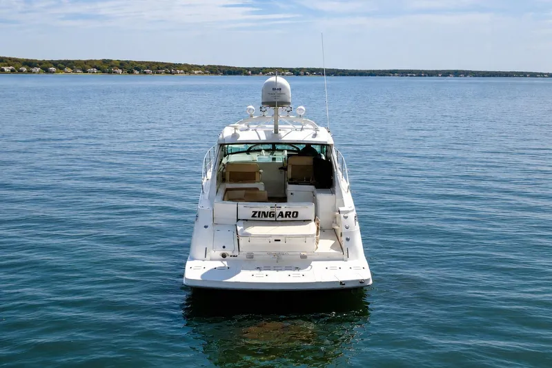 Slide: The Image of 2013 Sea Ray 450 Sundancer yacht on calm water, rear view. - 6