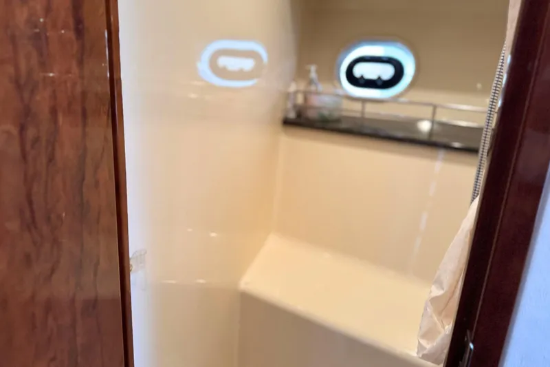 Slide: The Image of Interior of 2013 Sea Ray 450 Sundancer yacht bathroom with porthole window. - 60