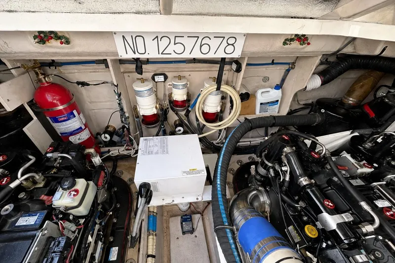 Slide: The Image of Engine room of a 2013 Sea Ray 450 Sundancer with equipment and fire extinguisher. - 61