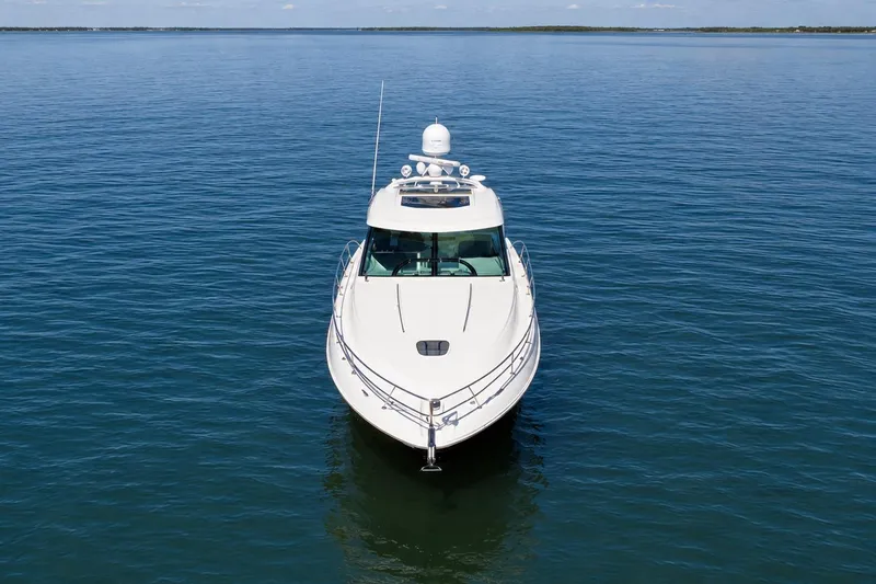 Slide: The Image of 2013 Sea Ray 450 Sundancer yacht on calm blue water, front view. - 7