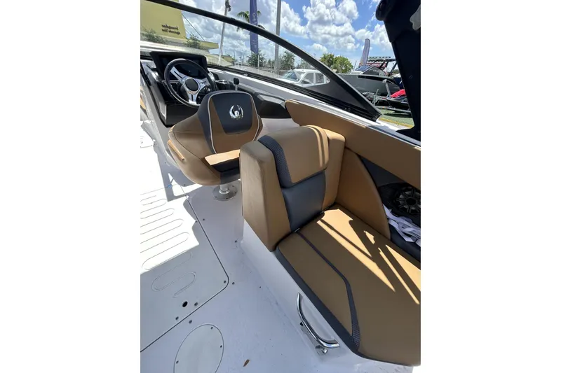 Slide: The Image of 2019 Scarab 255 ID boat interior with tan and gray seating, steering wheel, and dashboard. - 11