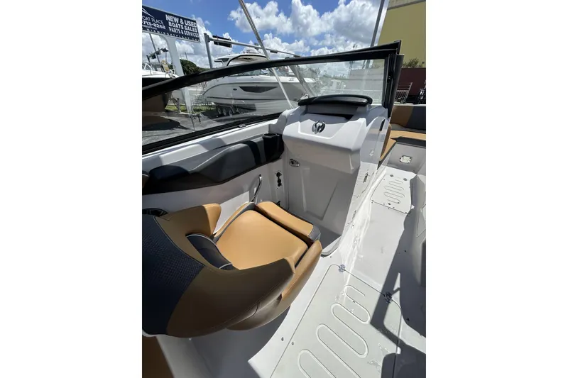Slide: The Image of 2019 Scarab 255 ID boat interior with tan seating and modern dashboard design. - 22