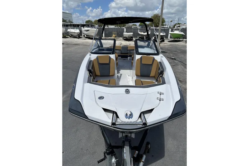 Slide: The Image of 2019 Scarab 255 ID boat with sleek design and spacious seating, parked outdoors. - 7