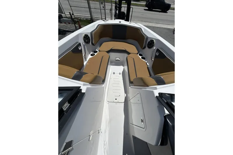Slide: The Image of 2019 Scarab 255 ID boat interior with tan seating and cup holders. - 9