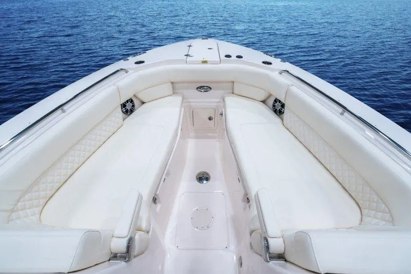 Slide: The Image of 2027 Grady-White Freedom 307 boat interior with luxurious seating on calm water. - 13