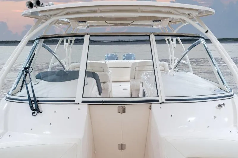 Slide: The Image of 2027 Grady-White Freedom 307 boat, showcasing sleek design and spacious seating on calm waters. - 14