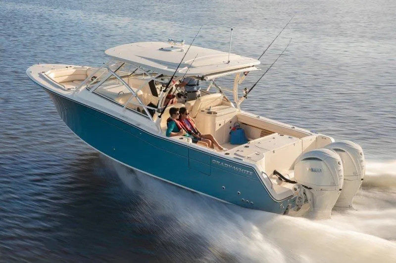 Slide: The Image of 2027 Grady-White Freedom 307 boat cruising on water with passengers enjoying the ride. - 2