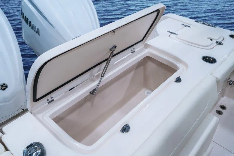 Slide: The Image of 2027 Grady-White Freedom 307 boat with open storage compartment, showcasing spacious design. - 3