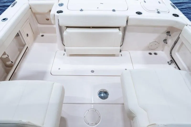 Slide: The Image of 2027 Grady-White Freedom 307 boat interior with white seating and spacious deck layout. - 5