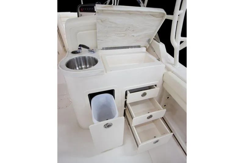 Slide: The Image of Grady-White Freedom 307 boat interior with sink, storage drawers, and trash compartment, 2027 model. - 6