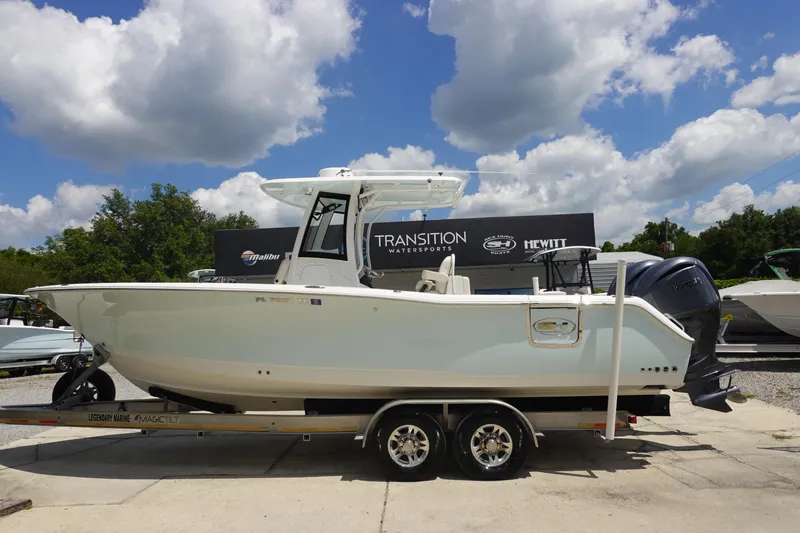 The Image of 2022 Sea Hunt Gamefish 27 Coffin Box boat on trailer under blue sky. - 0