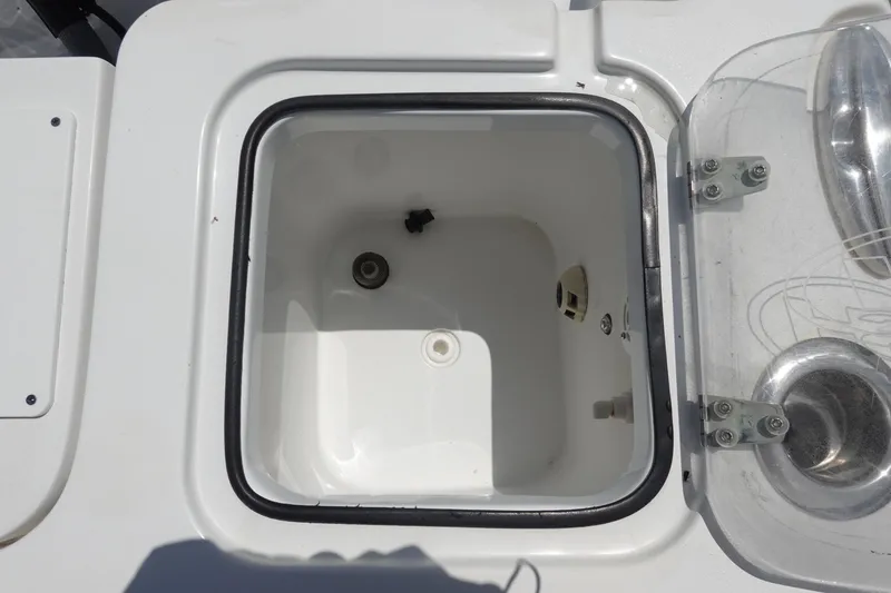 Slide: The Image of 2022 Sea Hunt Gamefish 27 Coffin Box interior with open lid, showcasing storage space. - 10