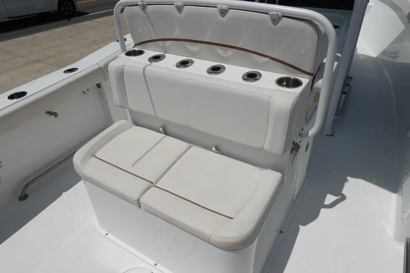 Slide: The Image of 2022 Sea Hunt Gamefish 27 Coffin Box boat seating with cup holders and white upholstery. - 11