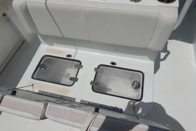 Slide: The Image of 2022 Sea Hunt Gamefish 27 Coffin Box interior with storage compartments and seating. - 12